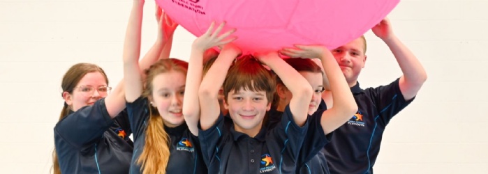 Marine Academy Plymouth Students holding up a pink ball. 